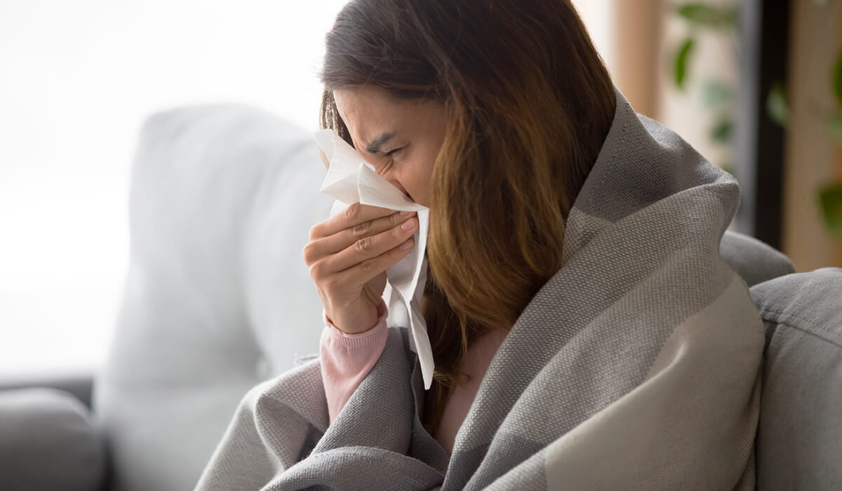 woman on the couch deals with one of the most common respiratory illnesses