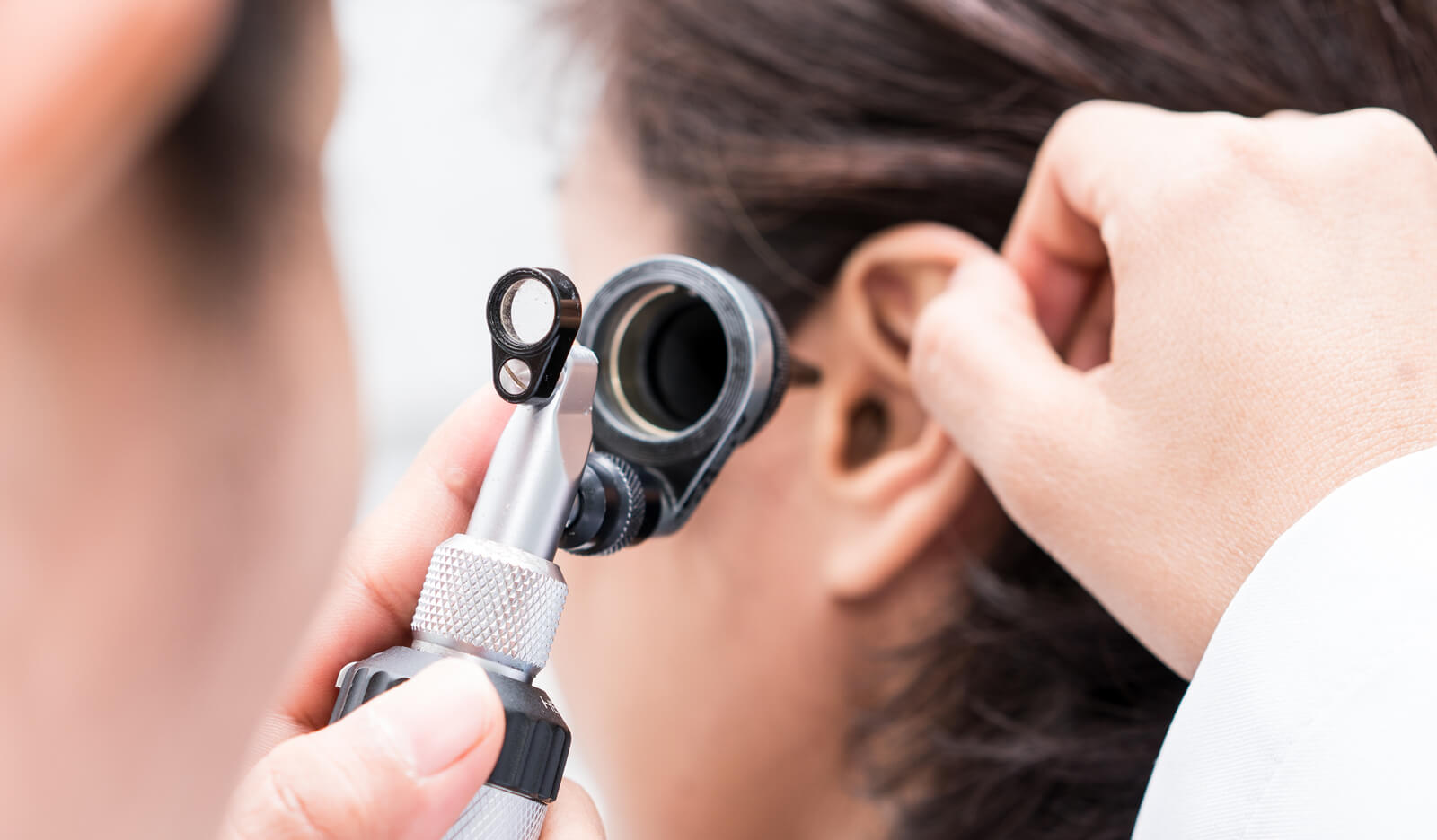 A doctor examines patient with an inner ear disorder