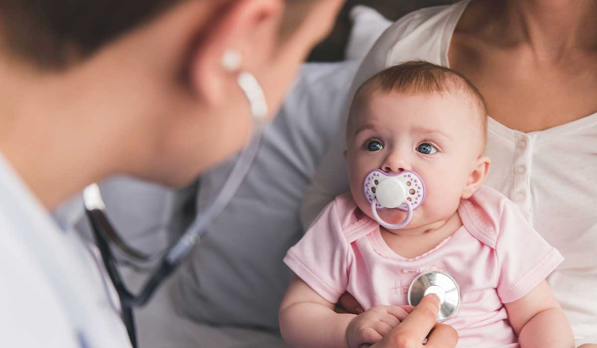 pediatrician listening to baby heartbeat
