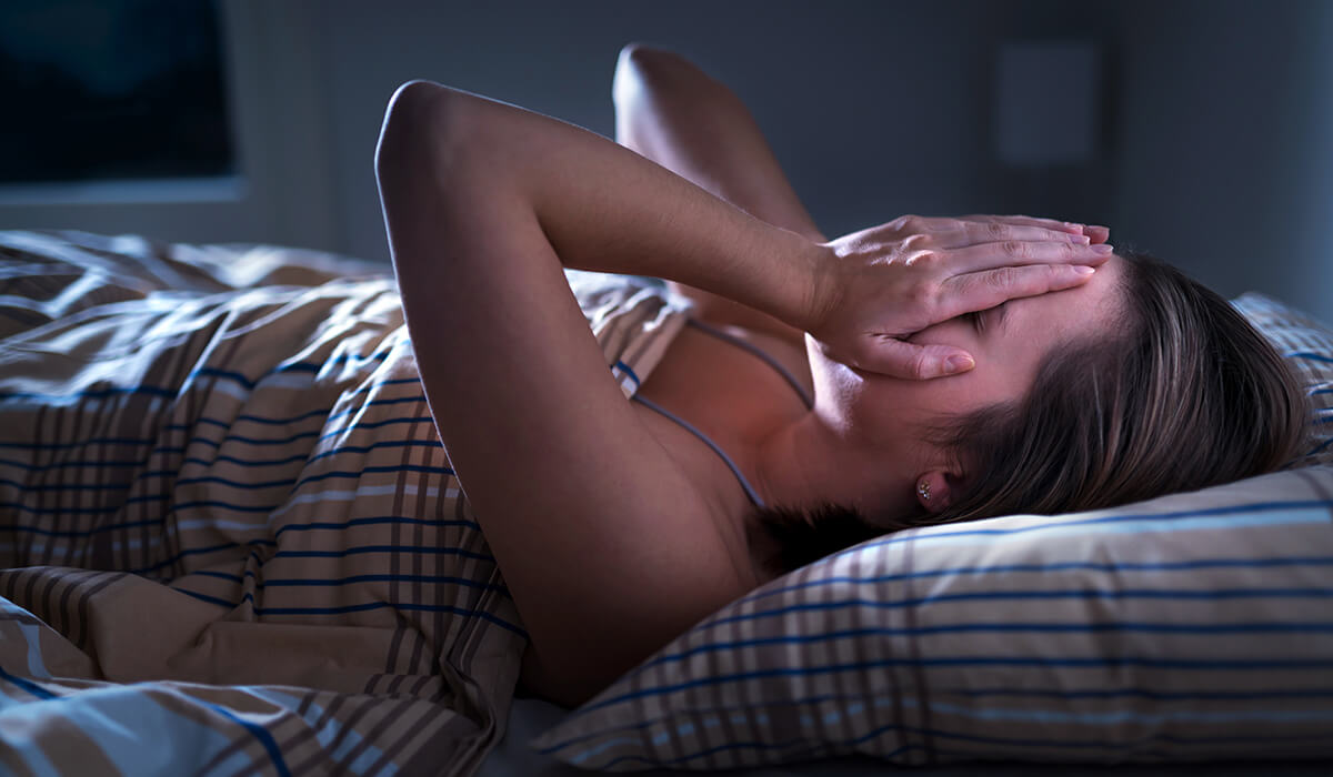 woman awake in the middle of the night wonders how to sleep better