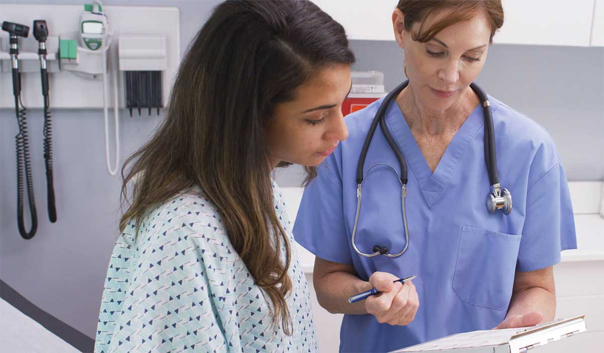 young woman looking at HPV test results with her gynecologist